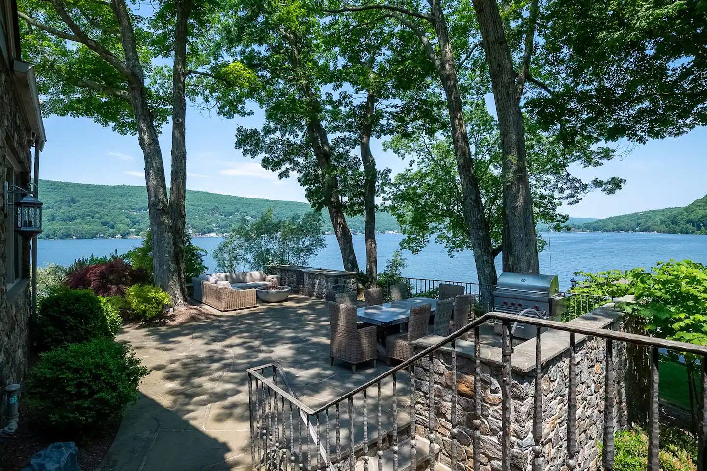 Outdoor dining area with full lake views, firepit . . . you won't want to eat indoors after this